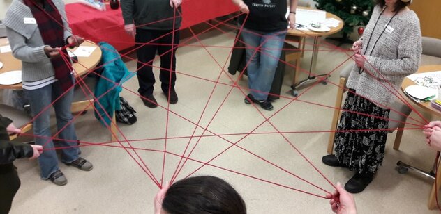support web picture of people forming a web or net with yarn